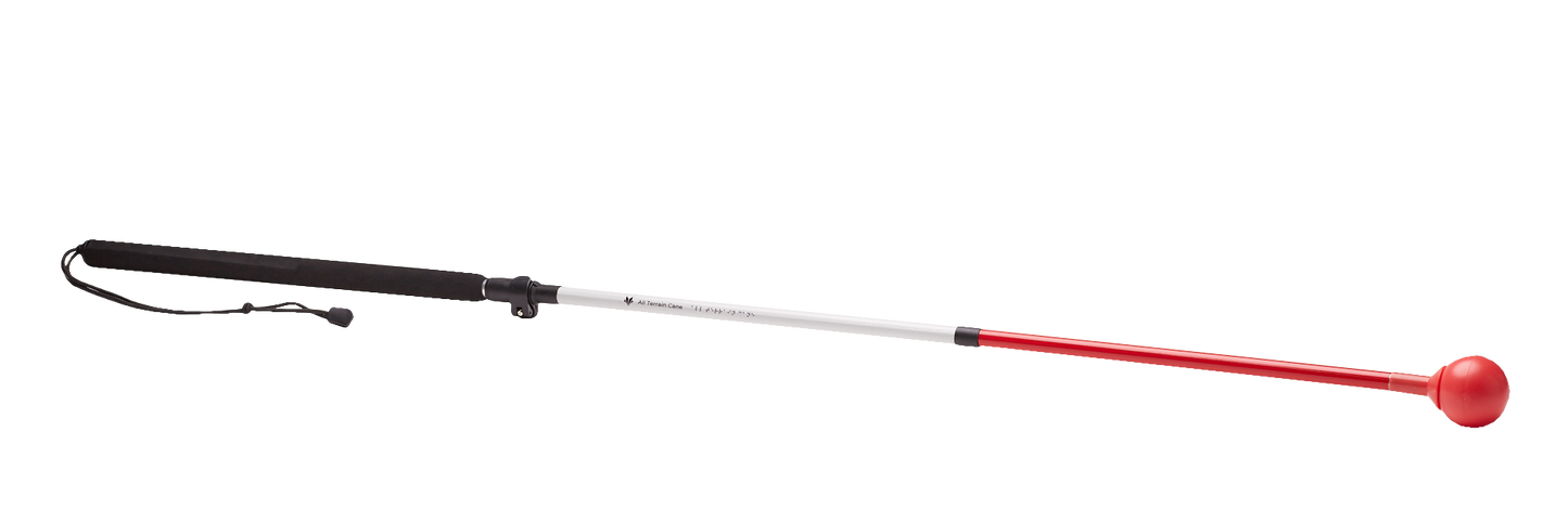 A white and red folding cane with a large red roller ball tip and a black wrist strap. The cane is designed for use on various terrains, including uneven surfaces and outdoors.