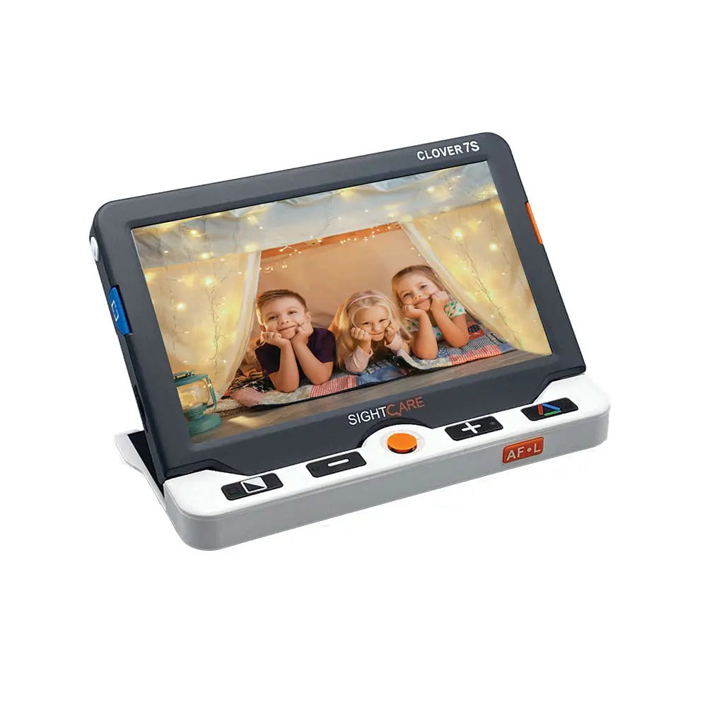 A white and black Floridareading Clover 7S HD video magnifier is shown. The screen is displaying a photo of three children smiling. The buttons on the side are clearly visible.