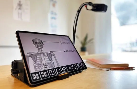 A Florida Reading MagniLink WifiCam connected to a tablet, displaying a magnified image of a human skeleton.