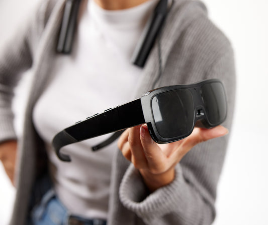 A women holding eSight Go Glasses in her hand.