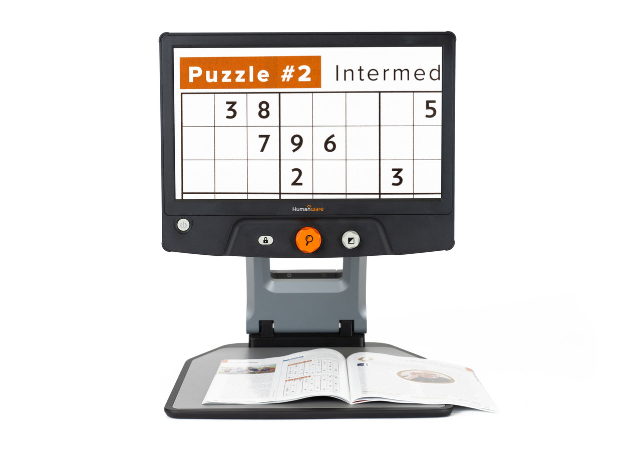 A Reveal 16 magnifier displaying a crossword puzzle, showcasing its clear and adjustable screen.